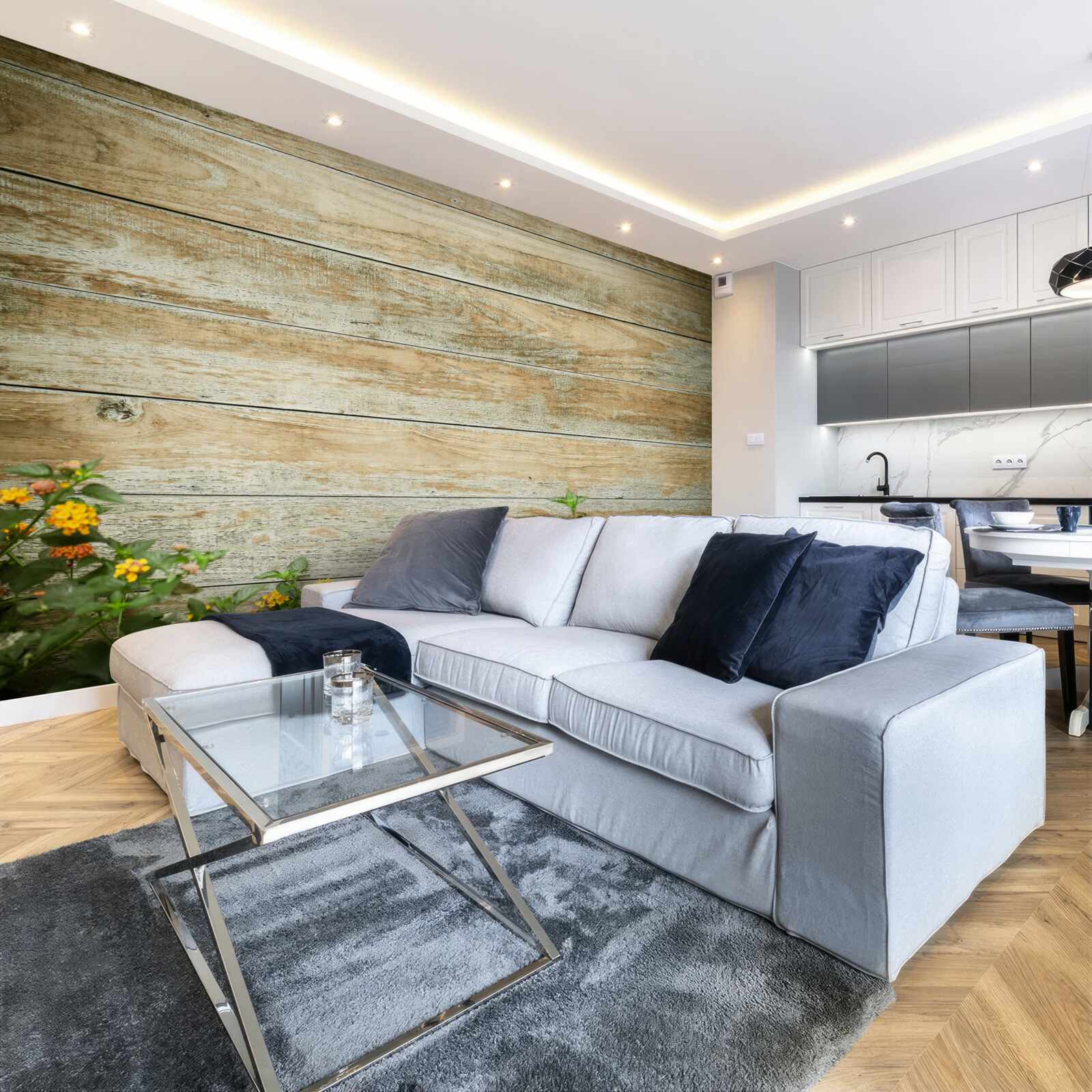 Fototapeta Na pozadí parketovej podlahy obklopenej zeleňou sú žlté kvety